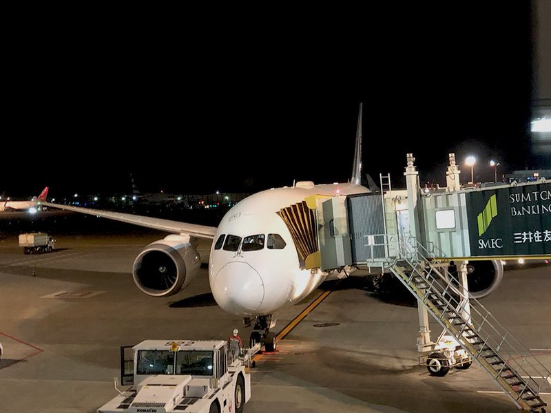 JAL B787 Dreamliner parked at the end of the jetbridge at Narita Airport.