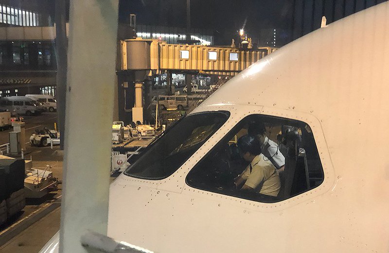 The pilots on the B787 Dreamliner of JL711 preparing for take off.