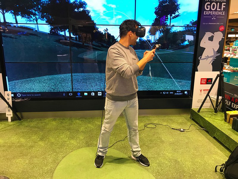 Leo trying out the VR golfing experience at Sydney International Airport.