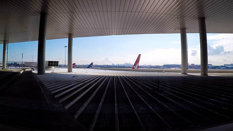 The iconic Sydney skyline from inside the Qantas Business Lounge at Sydney International Airport. The tail of the my American Airlines Boeing 787-9 Dreamliner is just visible in the middle.